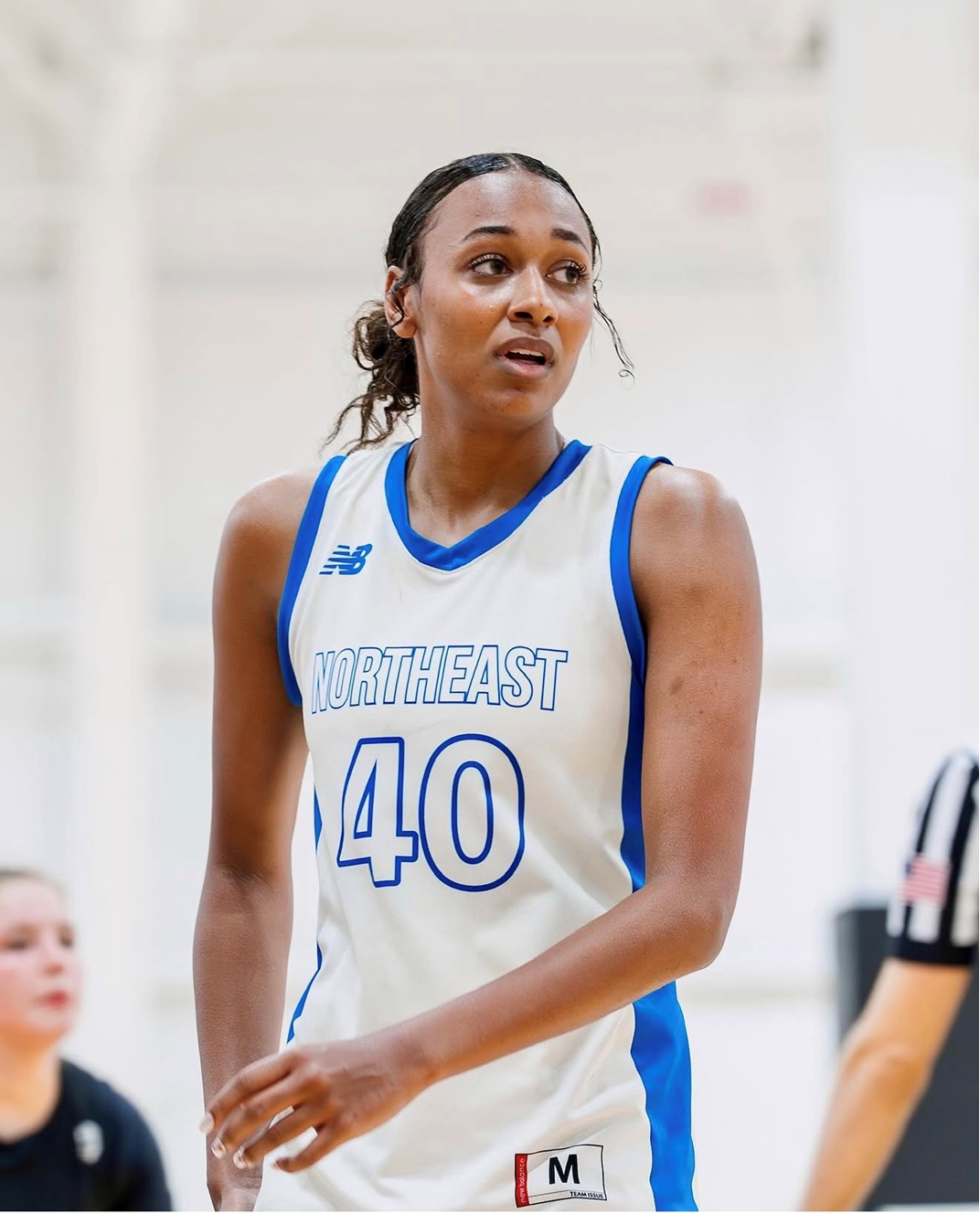 Team Northeast forward in a white and blue jersey during a tournament game